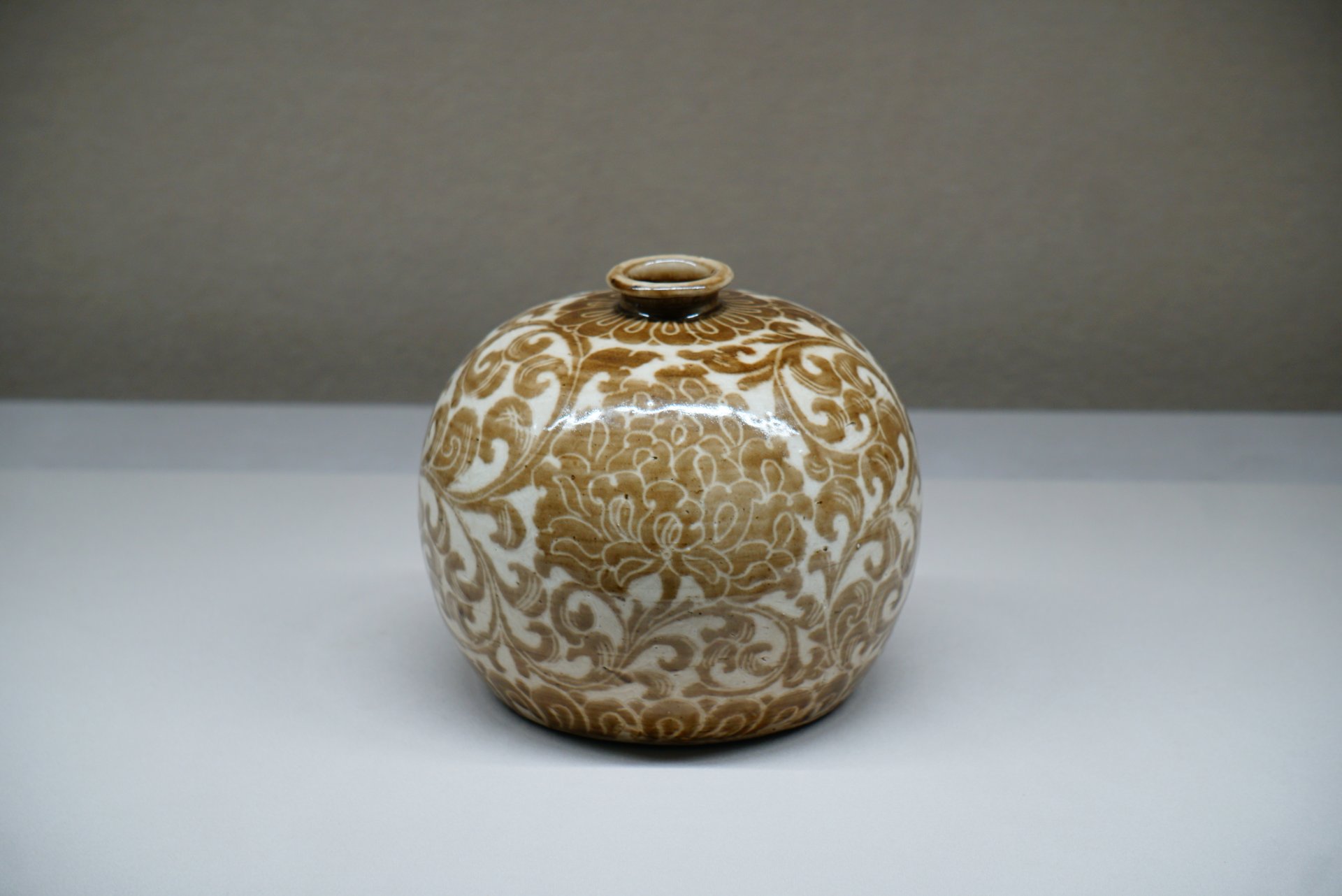 Bottle, porcelain with sgraffito design of peony scrolls carved through underglaze iron-brown slip