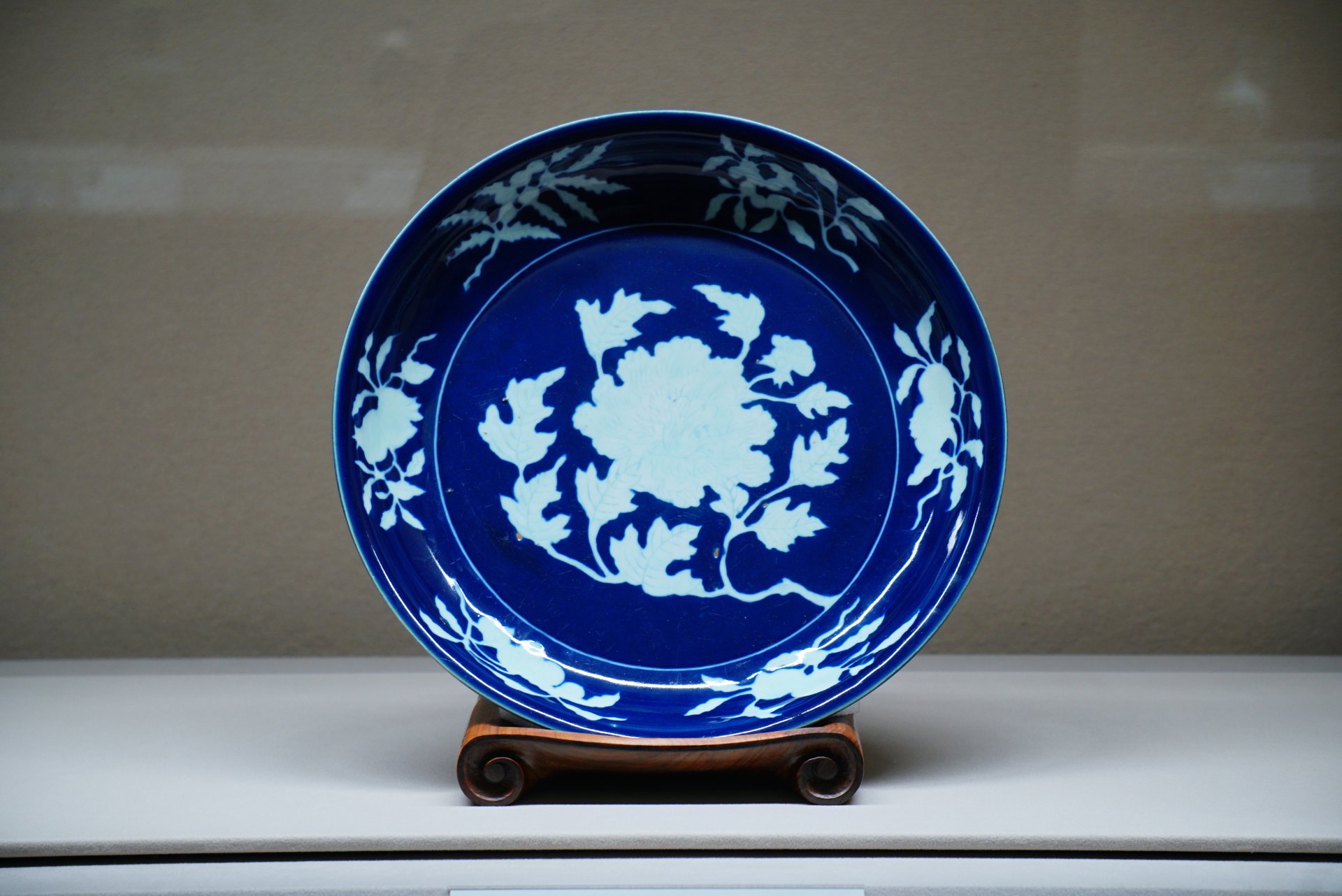 Dish, porcelain with design of a peony spray reserved against the cobalt blue ground