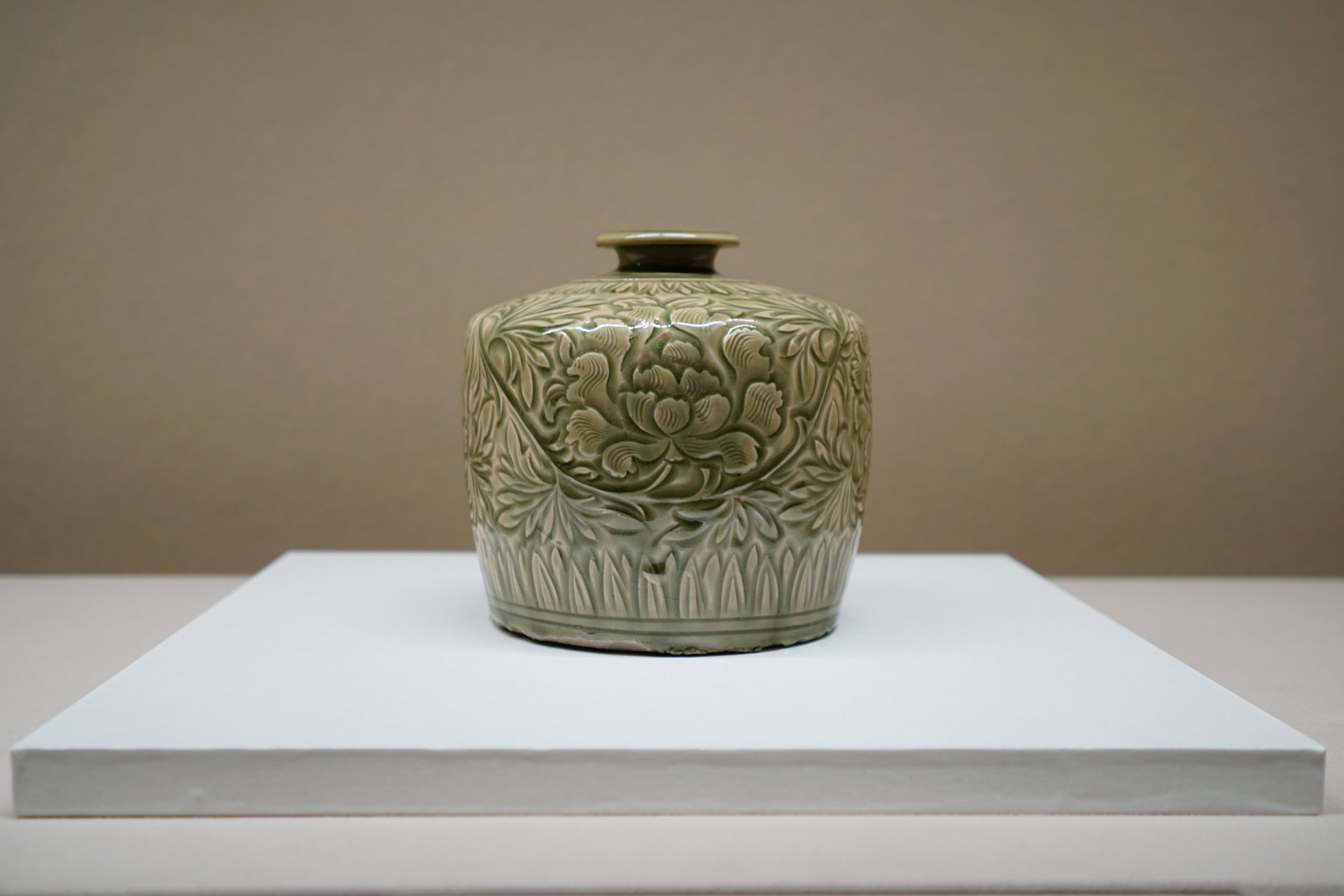 Bottle, celadon with carved peony scroll design
